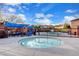 Outdoor community pool with sunshades, furniture, and a round jacuzzi tub at 5434 Fawn Chase Way, Las Vegas, NV 89135