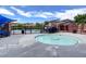 Community pool with a round jacuzzi tub, furniture, and a building at 5434 Fawn Chase Way, Las Vegas, NV 89135