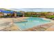 Community pool featuring lounge chairs, shaded seating areas, and clean, clear water at 5434 Fawn Chase Way, Las Vegas, NV 89135