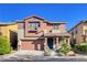 Charming two-story home with desert landscaping, a two-car garage, and a covered front porch at 5434 Fawn Chase Way, Las Vegas, NV 89135