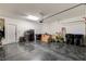 Garage with epoxy flooring featuring ample storage space, an automatic door, and bright lighting at 5434 Fawn Chase Way, Las Vegas, NV 89135