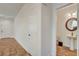 Hallway view with hardwood style flooring leading to bathroom with pedestal sink at 5434 Fawn Chase Way, Las Vegas, NV 89135