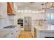 Modern kitchen featuring stainless steel appliances, a gas cooktop, and a large island with seating at 5434 Fawn Chase Way, Las Vegas, NV 89135