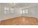 The bright living room has wood-look flooring, stylish shutters, and a modern chandelier at 5434 Fawn Chase Way, Las Vegas, NV 89135