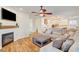 Cozy living room with a fireplace, TV, comfortable seating, and an open view into the kitchen at 5434 Fawn Chase Way, Las Vegas, NV 89135