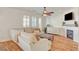 Cozy living room with plush seating, fireplace, and a ceiling fan at 5434 Fawn Chase Way, Las Vegas, NV 89135