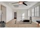 Upstairs loft area with carpet flooring, ceiling fan, and natural light from shuttered windows at 5434 Fawn Chase Way, Las Vegas, NV 89135
