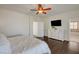 Light-filled main bedroom features wood floors, white walls, a ceiling fan and a doorway to the ensuite at 5434 Fawn Chase Way, Las Vegas, NV 89135