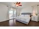 Serene main bedroom with private balcony access, dark wood floors, and a ceiling fan at 5434 Fawn Chase Way, Las Vegas, NV 89135