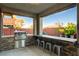 Built-in outdoor kitchen with a grill and bar-style seating at 5434 Fawn Chase Way, Las Vegas, NV 89135