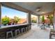 Covered patio with outdoor seating, a bar area, and views of the landscaped backyard at 5434 Fawn Chase Way, Las Vegas, NV 89135