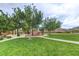 Neighborhood playground featuring mature trees, picnic benches, and a green lawn at 5434 Fawn Chase Way, Las Vegas, NV 89135