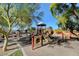 Community playground with slides, climbing structures, and shaded seating area at 5434 Fawn Chase Way, Las Vegas, NV 89135