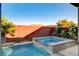 Inviting backyard pool with a spa, surrounded by lush landscaping and privacy wall at 5434 Fawn Chase Way, Las Vegas, NV 89135