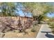 Community entrance sign amidst desert landscaping, marking the 'Ladera' community with elegant stone at 5434 Fawn Chase Way, Las Vegas, NV 89135