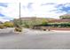 Well maintained community street view surrounded by desert landscaping and picturesque mountain views at 5434 Fawn Chase Way, Las Vegas, NV 89135