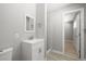 Updated bathroom featuring a white vanity and a shower with tiled walls at 5817 Glen Eagles Ln, Las Vegas, NV 89108