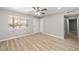 Bright bedroom featuring wood floors, a ceiling fan, a window, and neutral paint at 5817 Glen Eagles Ln, Las Vegas, NV 89108