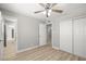Spacious bedroom with wood floors, ceiling fan, ample closet space, and neutral colors at 5817 Glen Eagles Ln, Las Vegas, NV 89108