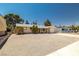 Charming single-story home featuring a gravel yard, attached garage, and mature trees at 5817 Glen Eagles Ln, Las Vegas, NV 89108
