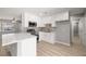 Well-equipped kitchen features stainless steel appliances, white cabinets, and a quartz island at 5817 Glen Eagles Ln, Las Vegas, NV 89108