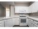 Bright kitchen with modern appliances, white cabinets, quartz counters, and stainless steel dishwasher at 5855 Valley Dr # 2161, North Las Vegas, NV 89031