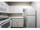 A bright kitchen boasts white cabinets, stainless steel appliances, and quartz countertops at 5855 Valley Dr # 2161, North Las Vegas, NV 89031