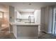 Kitchen features bright white cabinets, quartz countertops, modern faucet and updated appliances at 5855 Valley Dr # 2161, North Las Vegas, NV 89031