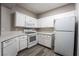 Bright kitchen with white cabinets, quartz countertops, microwave, range and a dishwasher at 5855 Valley Dr # 2161, North Las Vegas, NV 89031