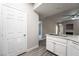 Open-concept living area with updated lighting, fireplace, stainless sink, and light, hard surface flooring at 5855 Valley Dr # 2161, North Las Vegas, NV 89031