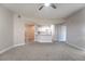 Open-concept living area with neutral paint, modern ceiling fan, and partial kitchen view at 5855 Valley Dr # 2161, North Las Vegas, NV 89031