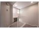 Upstairs loft area with small desk, carpet flooring, two windows and white railing at 5855 Valley Dr # 2161, North Las Vegas, NV 89031