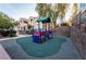 Community playground with colorful play structure and safety surface, near residential buildings at 5855 Valley Dr # 2161, North Las Vegas, NV 89031