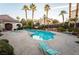 Community pool area featuring lounge chairs and palm trees, offering a relaxing outdoor space at 5855 Valley Dr # 2161, North Las Vegas, NV 89031