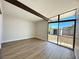 Bright bedroom with large window, beam, and durable wood-look flooring at 6261 Rassler Ave, Las Vegas, NV 89107