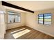 Sun-filled bedroom with hardwood flooring, exposed beam, and view of the neighborhood at 6261 Rassler Ave, Las Vegas, NV 89107