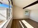 Bright bedroom featuring hardwood floors and large windows with ample natural light at 6261 Rassler Ave, Las Vegas, NV 89107