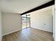 Bright bedroom with large window, beam, and durable wood-look flooring at 6261 Rassler Ave, Las Vegas, NV 89107