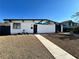 Charming single-story home with a xeriscaped front yard and modern architectural details at 6261 Rassler Ave, Las Vegas, NV 89107