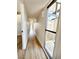 Long bright hallway with modern lighting, fresh paint, and durable wood-look flooring at 6261 Rassler Ave, Las Vegas, NV 89107