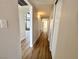 Bright hallway features modern lighting, fresh paint, and durable wood-look flooring at 6261 Rassler Ave, Las Vegas, NV 89107