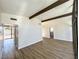 Open and airy living room featuring wood floors, beamed ceilings, and expansive windows at 6261 Rassler Ave, Las Vegas, NV 89107