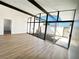 Bright and open living room with hardwood floors, beamed ceilings, and large windows at 6261 Rassler Ave, Las Vegas, NV 89107