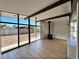 Bright living room with large windows, hardwood floors, a cozy fireplace, and an open concept floor plan at 6261 Rassler Ave, Las Vegas, NV 89107