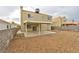 Exterior view of the home's backyard featuring gravel landscaping and a covered patio at 6388 Canyon Dawn Ave, Las Vegas, NV 89108