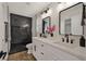 Modern bathroom with dual sinks, marble shower, and sleek black fixtures at 6388 Canyon Dawn Ave, Las Vegas, NV 89108