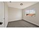 Minimalist bedroom with soft gray walls, new carpet, and bright window view at 6388 Canyon Dawn Ave, Las Vegas, NV 89108