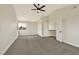 Bright bedroom offers gray carpet, a modern ceiling fan, fresh paint, and a large window at 6388 Canyon Dawn Ave, Las Vegas, NV 89108