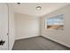 Minimalist bedroom with soft gray walls, new carpet, and bright window view at 6388 Canyon Dawn Ave, Las Vegas, NV 89108