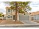 Charming two-story home with desert landscaping, a tile roof and an attached two car garage at 6388 Canyon Dawn Ave, Las Vegas, NV 89108